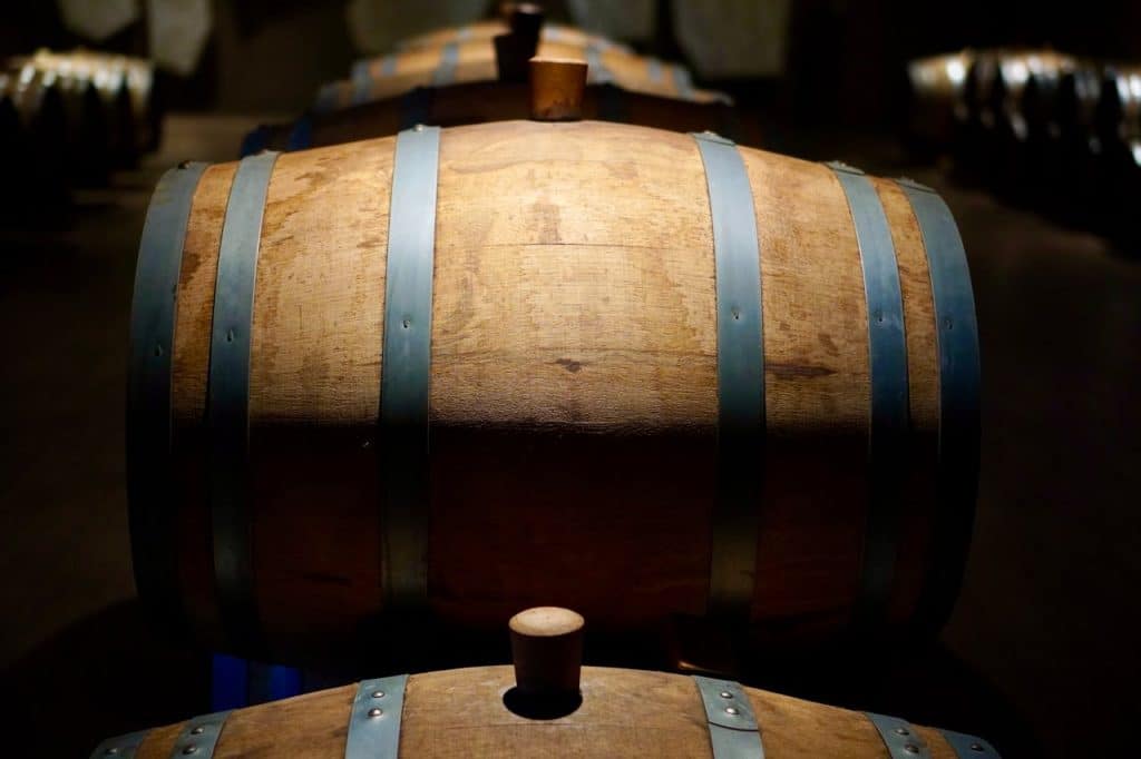 barrels-in-a-basement-19866381 Barrels in a shadowed winery cellar, perfect for wine aging imagery.